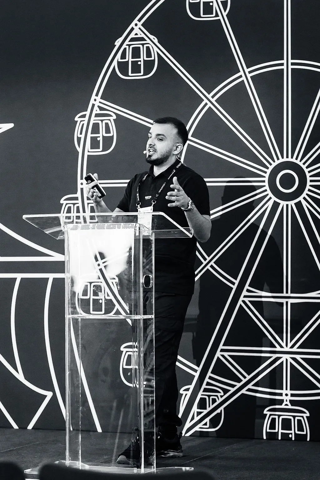 Ramial Aqeel speaking at a paid media conference, mid-talk at the lectern